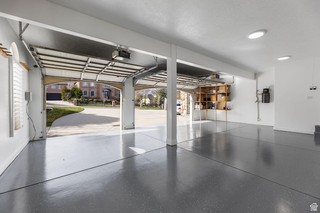 garage featuring baseboards and a garage door opener