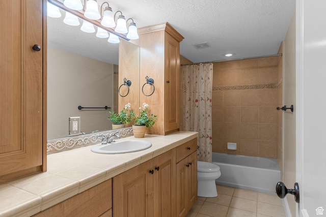bathroom featuring vanity, tile patterned flooring, a textured ceiling, toilet, and visible vents