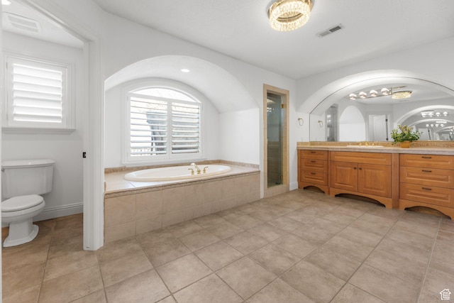 bathroom with visible vents, toilet, a shower stall, vanity, and a garden tub