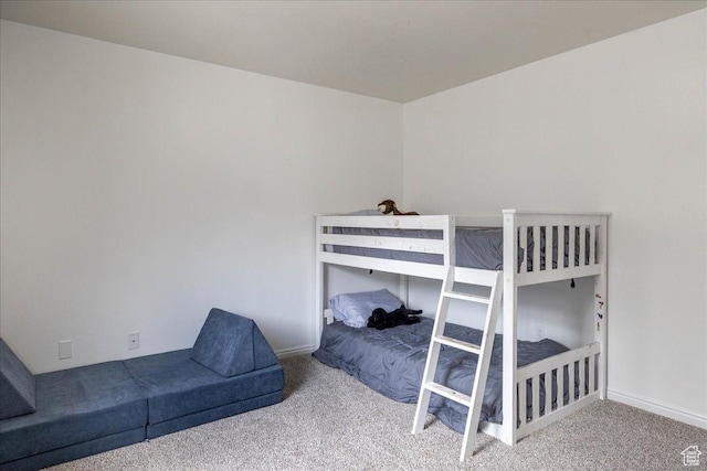 bedroom featuring baseboards and carpet