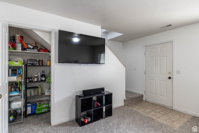 interior space with baseboards, visible vents, and carpet flooring