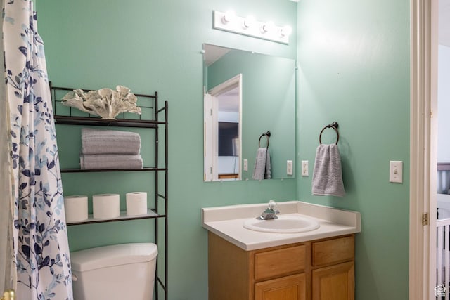 bathroom featuring toilet and vanity