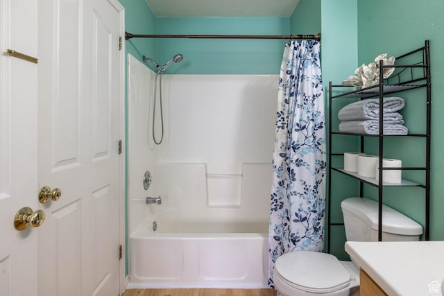 bathroom featuring wood finished floors, toilet, vanity, and shower / bath combination with curtain