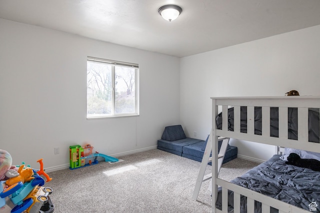 bedroom with baseboards and carpet