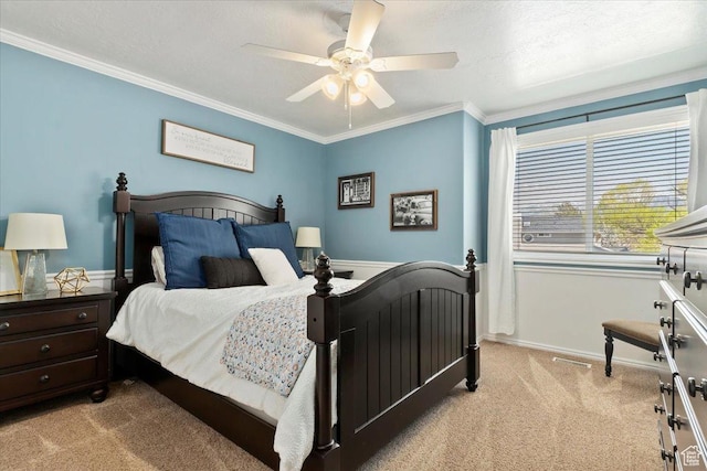 bedroom featuring ceiling fan, a textured ceiling, ornamental molding, carpet floors, and baseboards