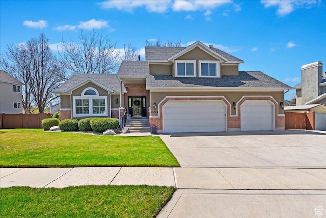 view of front of home featuring fence, stucco siding, brick siding, a front lawn, and driveway