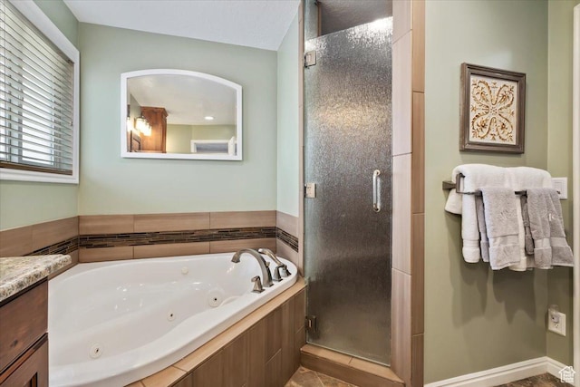 full bathroom with a whirlpool tub, a stall shower, and vanity