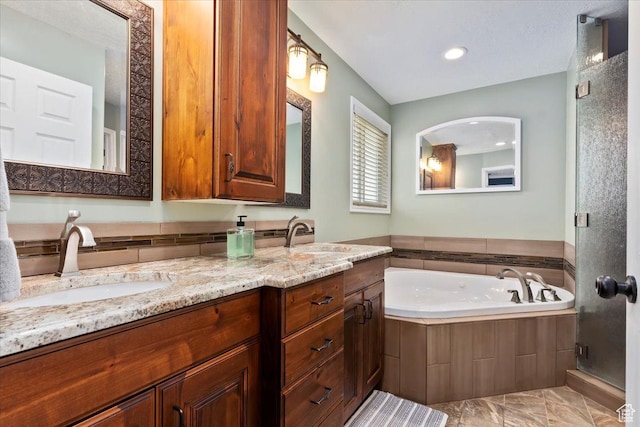 bathroom with a bath, double vanity, a sink, and a stall shower