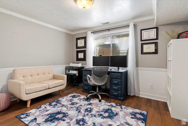 office area featuring dark wood-style flooring, baseboards, a textured ceiling, crown molding, and visible vents