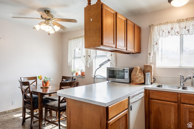 1083 N 1250 W, Layton, UT 84041 - kitchen featuring dishwasher, a sink, light countertops, a peninsula, and brown cabinetry