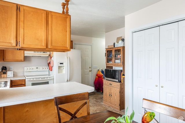 1083 N 1250 W, Layton, UT 84041 - kitchen featuring white appliances, brown cabinetry, a peninsula, under cabinet range hood, and light countertops