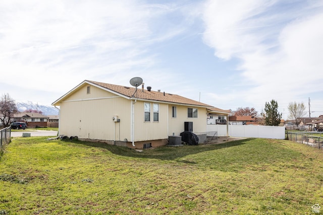 1083 N 1250 W, Layton, UT 84041 - back of property with a fenced backyard, cooling unit, and a lawn