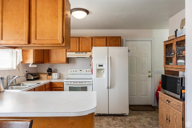 1083 N 1250 W, Layton, UT 84041 - kitchen with a sink, light countertops, white appliances, under cabinet range hood, and brown cabinetry