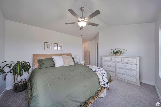 carpeted bedroom featuring baseboards, ceiling fan, and vaulted ceiling