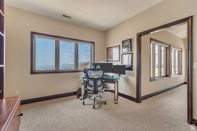 carpeted home office with visible vents, a wealth of natural light, and baseboards