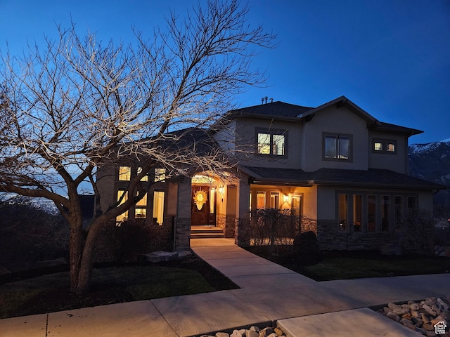 view of front of home featuring stucco siding and stone siding