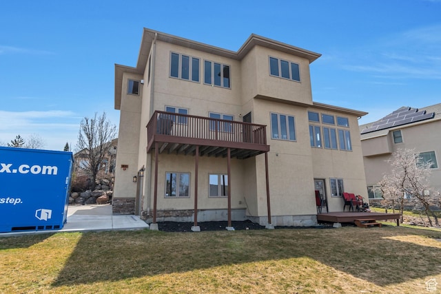 rear view of property with a yard and stucco siding
