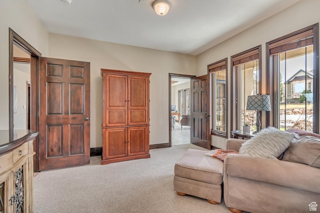 living room with light colored carpet and baseboards