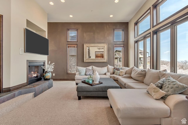 living room featuring carpet flooring, a fireplace, plenty of natural light, and recessed lighting