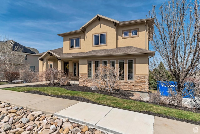 view of front of property with stone siding and stucco siding