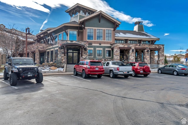 view of building exterior with uncovered parking