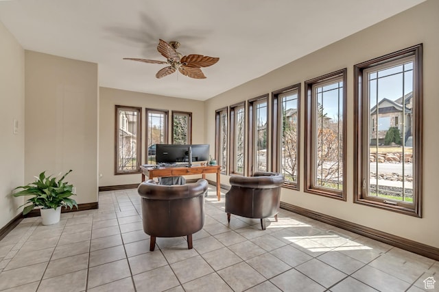 office space with baseboards, a ceiling fan, and light tile patterned flooring