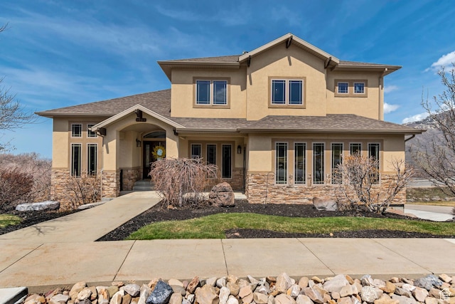 prairie-style home featuring stucco siding and stone siding