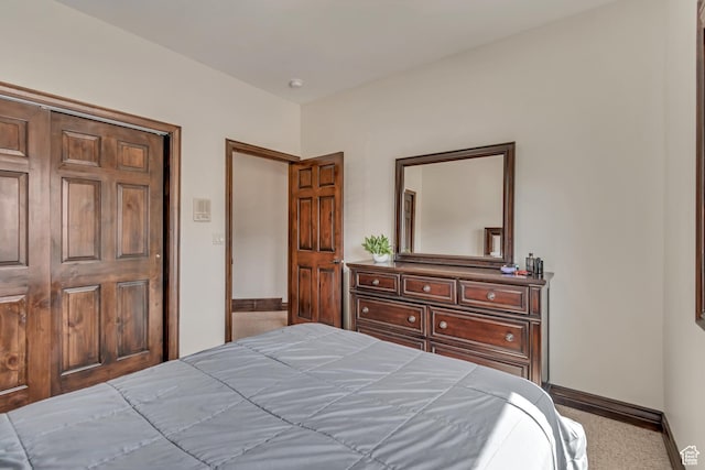 bedroom with carpet flooring and baseboards
