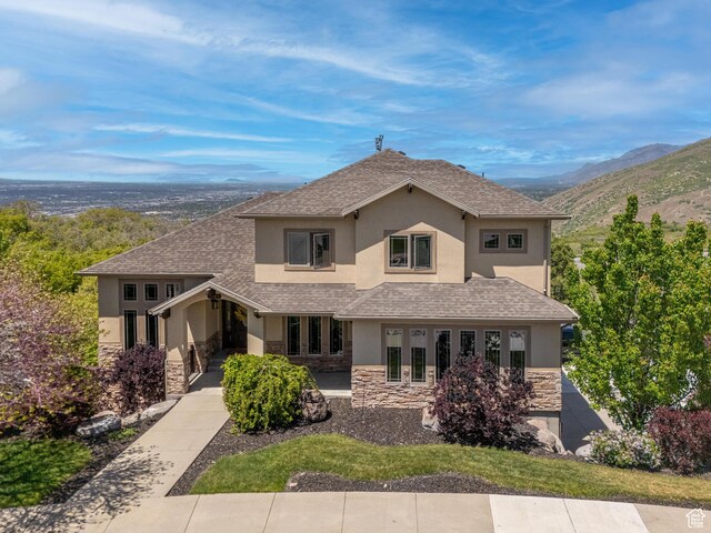 1945 E Seven Oaks Ln, Draper, UT 84020 - traditional-style house with stone siding, stucco siding, a mountain view, and roof with shingles