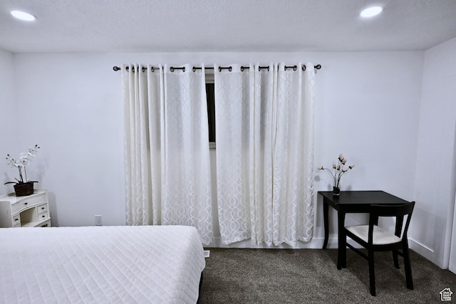 bedroom with a textured ceiling, dark colored carpet, and recessed lighting