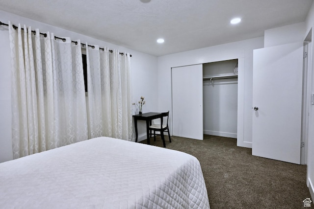 bedroom with a closet, baseboards, recessed lighting, and dark colored carpet