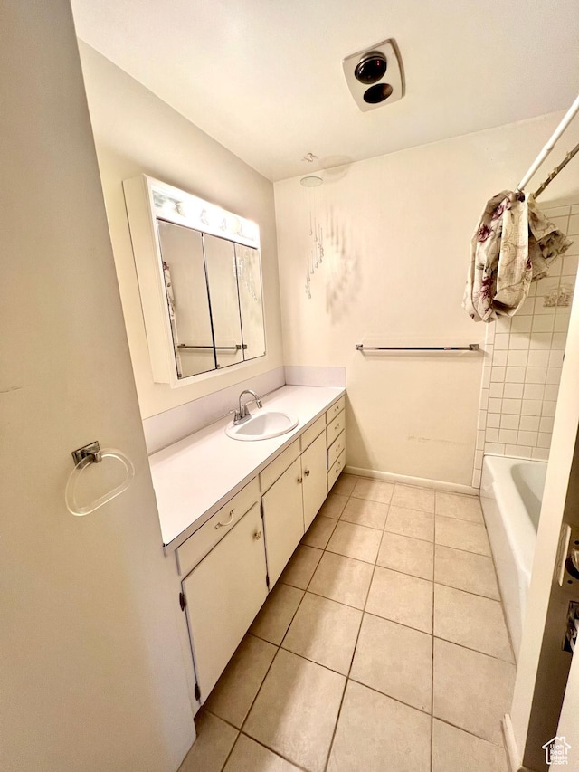 full bath with tile patterned floors, vanity, and baseboards