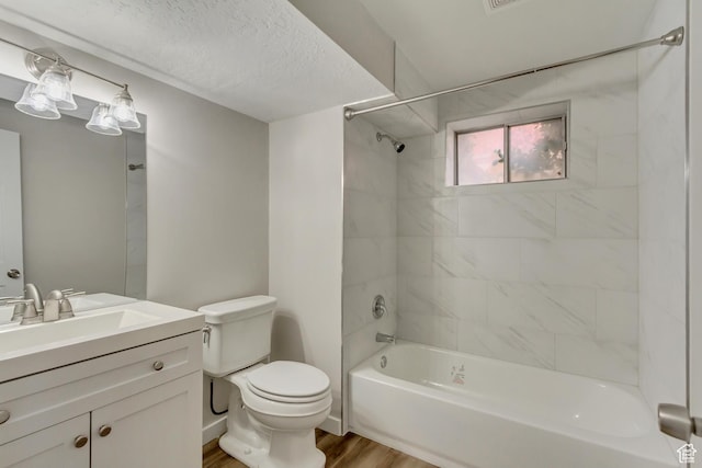 980 Hudson St, Ogden, UT 84404 - bathroom featuring vanity, a textured ceiling, toilet, tub / shower combination, and wood finished floors