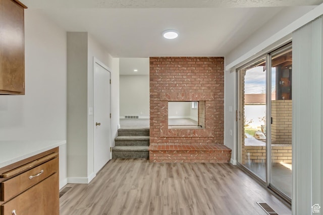 980 Hudson St, Ogden, UT 84404 - unfurnished living room featuring visible vents, baseboards, and light wood finished floors