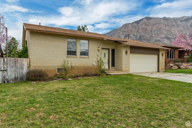 980 Hudson St, Ogden, UT 84404 - view of front of home with a front yard, fence, brick siding, a garage, and concrete driveway