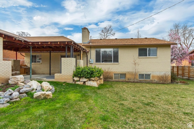 980 Hudson St, Ogden, UT 84404 - rear view of house with a yard, a chimney, fence, a patio, and brick siding