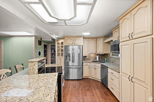 146 W 400 S, Tooele, UT 84074 - kitchen with tasteful backsplash, cream cabinets, dark wood-type flooring, appliances with stainless steel finishes, and a sink
