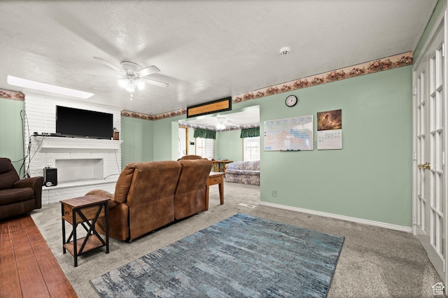 146 W 400 S, Tooele, UT 84074 - carpeted living room with a fireplace, a textured ceiling, baseboards, and ceiling fan