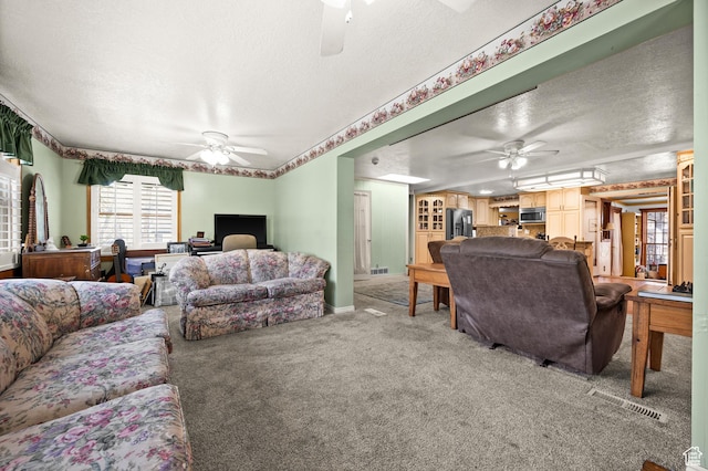 146 W 400 S, Tooele, UT 84074 - living room with visible vents, baseboards, a ceiling fan, a textured ceiling, and light carpet