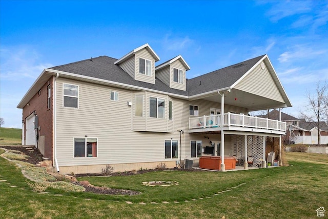 106 N Bear River Blfs, Preston, ID 83263 - back of property featuring a hot tub, a lawn, a wooden deck, and a garage