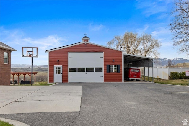 106 N Bear River Blfs, Preston, ID 83263 - view of outdoor structure featuring an outbuilding, fence, a mountain view, and driveway