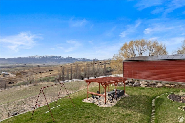 106 N Bear River Blfs, Preston, ID 83263 - view of yard with a mountain view, a pergola, a patio area, a playground, and a rural view