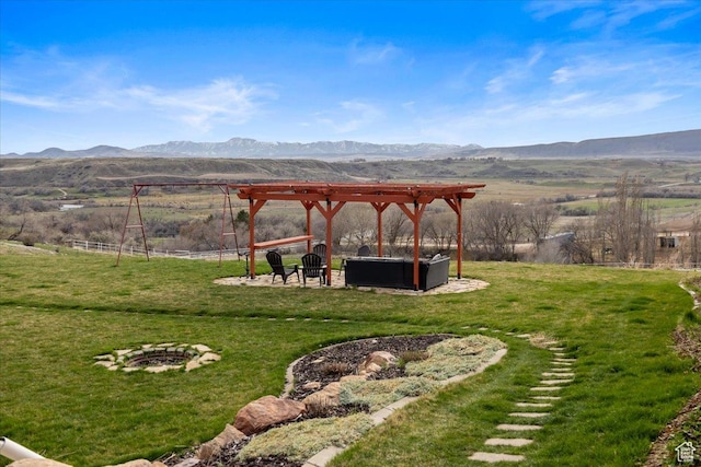 106 N Bear River Blfs, Preston, ID 83263 - view of grassy yard featuring a fire pit, a mountain view, a pergola, and a view of countryside