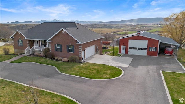 106 N Bear River Blfs, Preston, ID 83263 - ranch-style house featuring a mountain view, a front lawn, an outdoor structure, a detached garage, and driveway