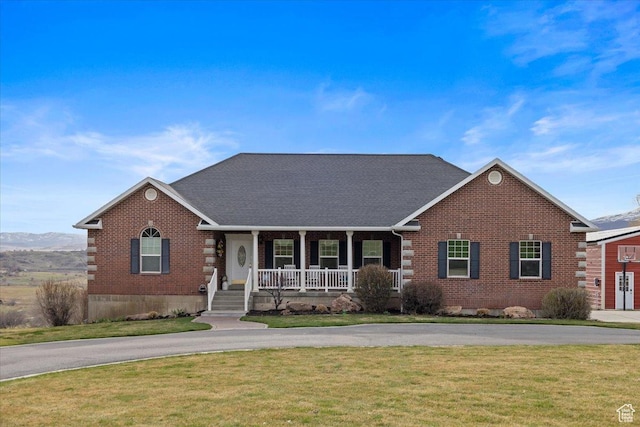 106 N Bear River Blfs, Preston, ID 83263 - view of front facade with covered porch, brick siding, a front yard, and curved driveway