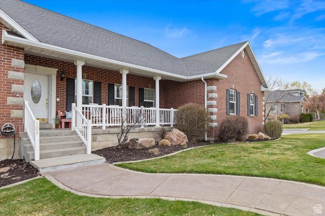106 N Bear River Blfs, Preston, ID 83263 - view of front of home featuring brick siding, covered porch, a front lawn, and roof with shingles