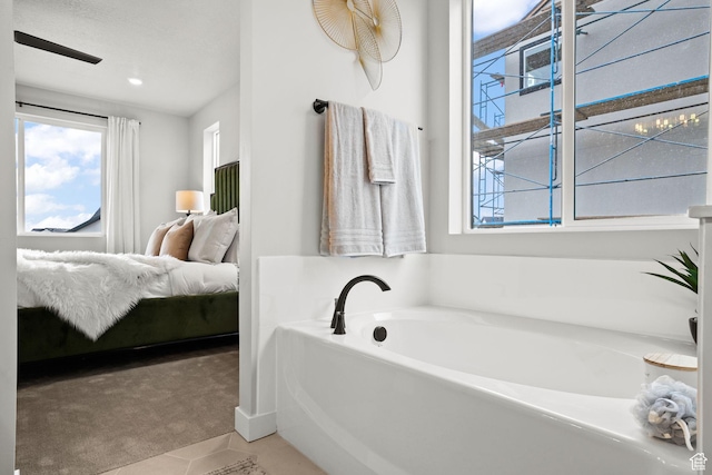 1514 E Livi Ln N Unit 10, Saratoga Springs, UT 84045 - ensuite bathroom featuring a garden tub and tile patterned floors