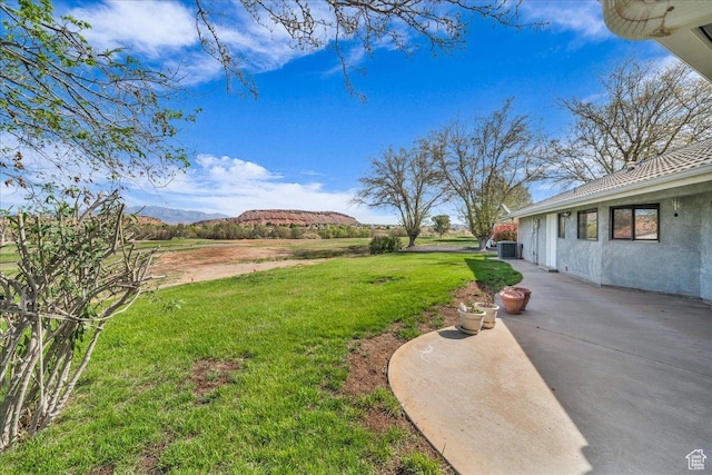view of yard with a patio area, cooling unit, and a mountain view