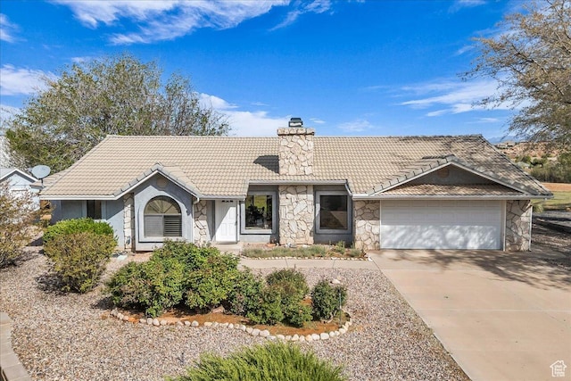 ranch-style house with a garage, stone siding, a tile roof, a chimney, and driveway
