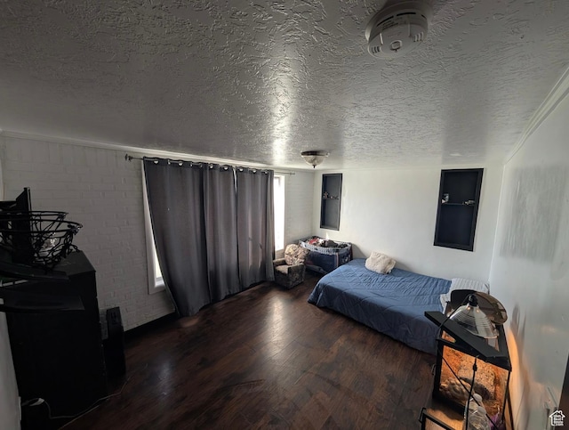bedroom featuring a textured ceiling and wood finished floors